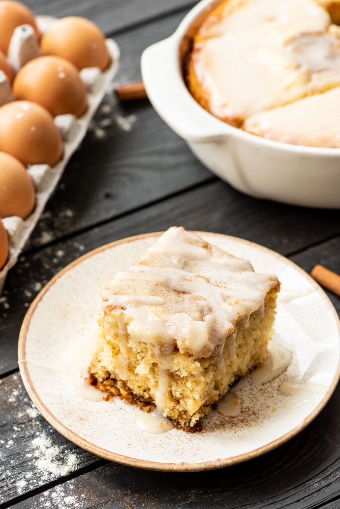 fluffy and flavor packed cake with bits of cinnamon throughout and an icing on top