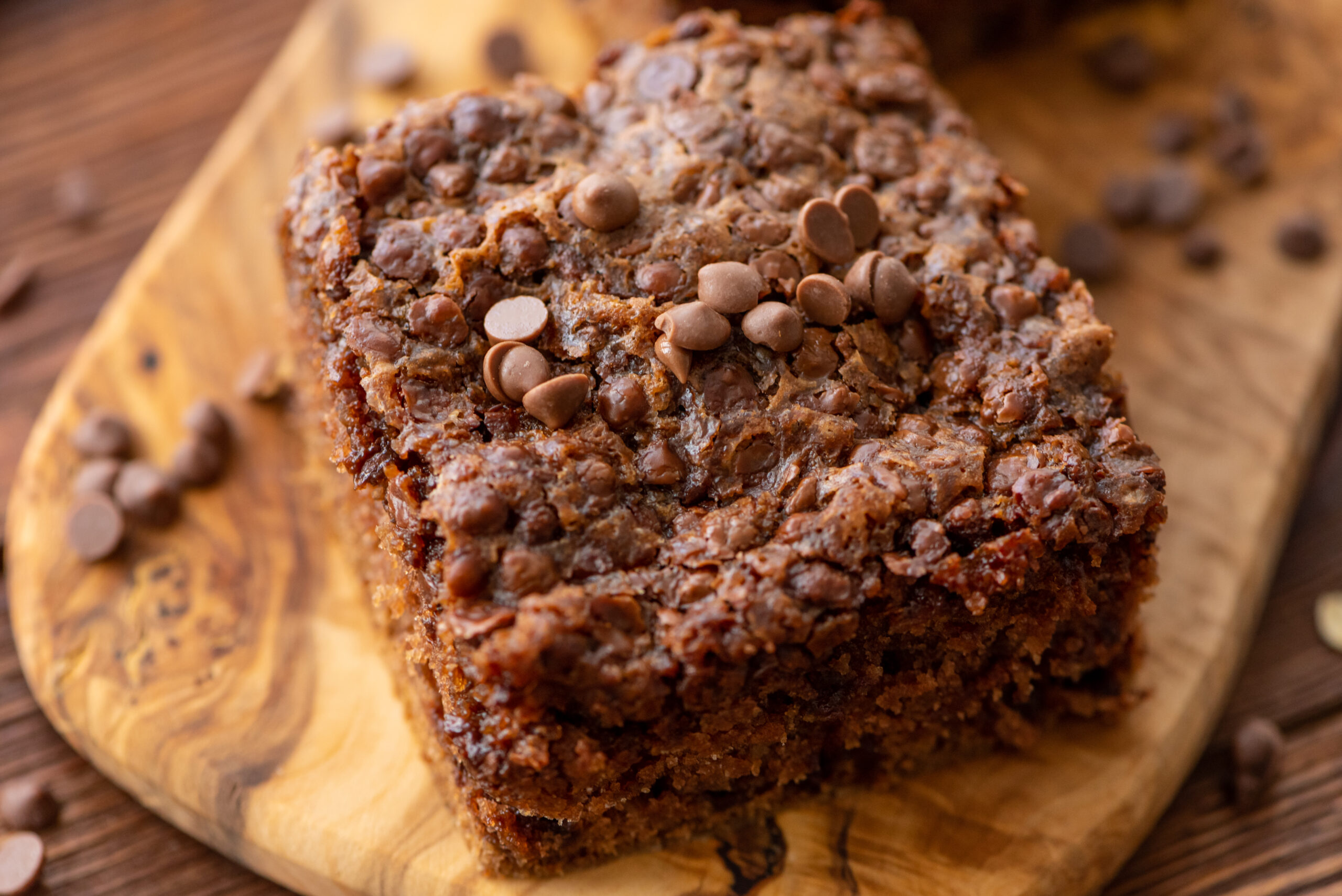 a piece of chocolate oatmeal cake on a wooden board ready to enjoy.
