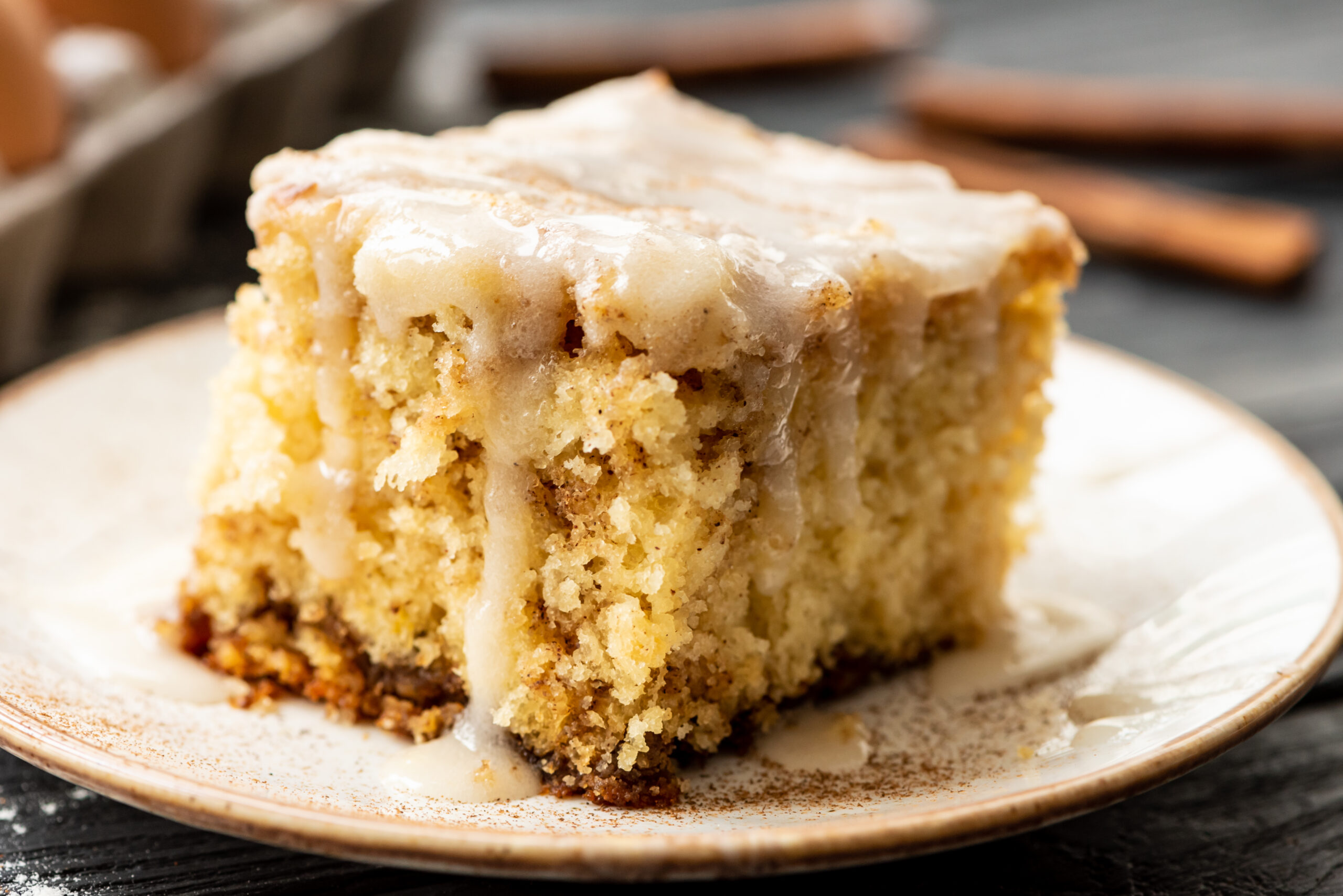 a piece of cinnamon roll coffee cake served on a small plate.