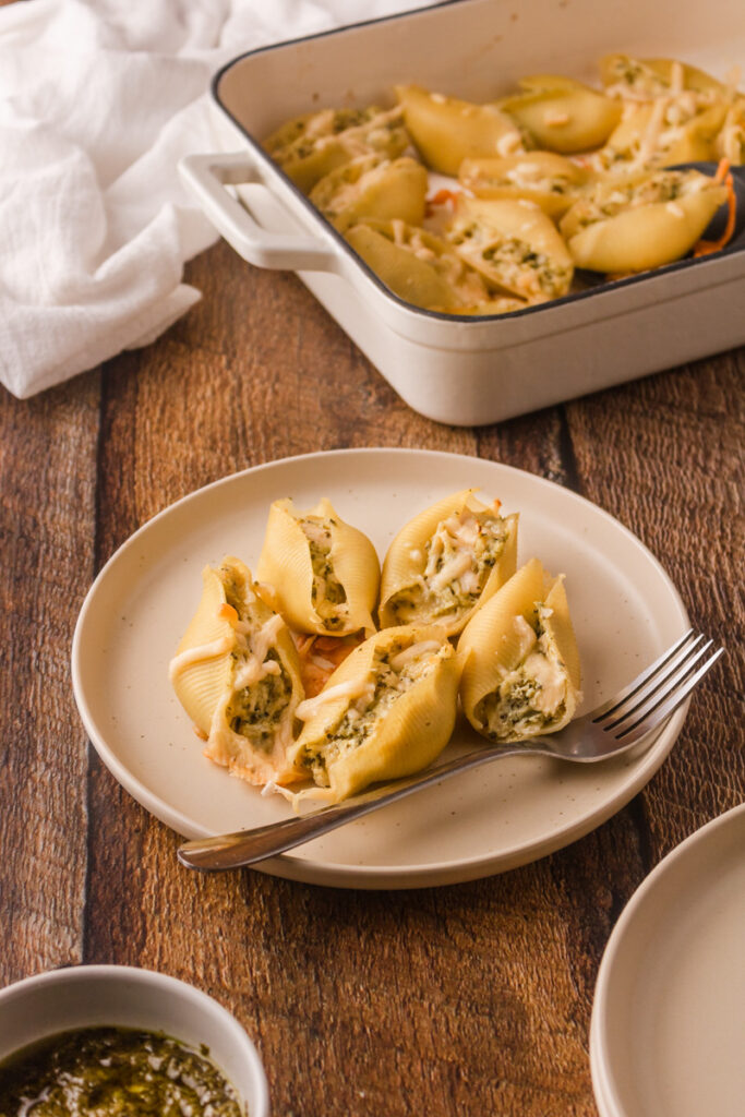 cooked pasta shells with pesto chicken inside