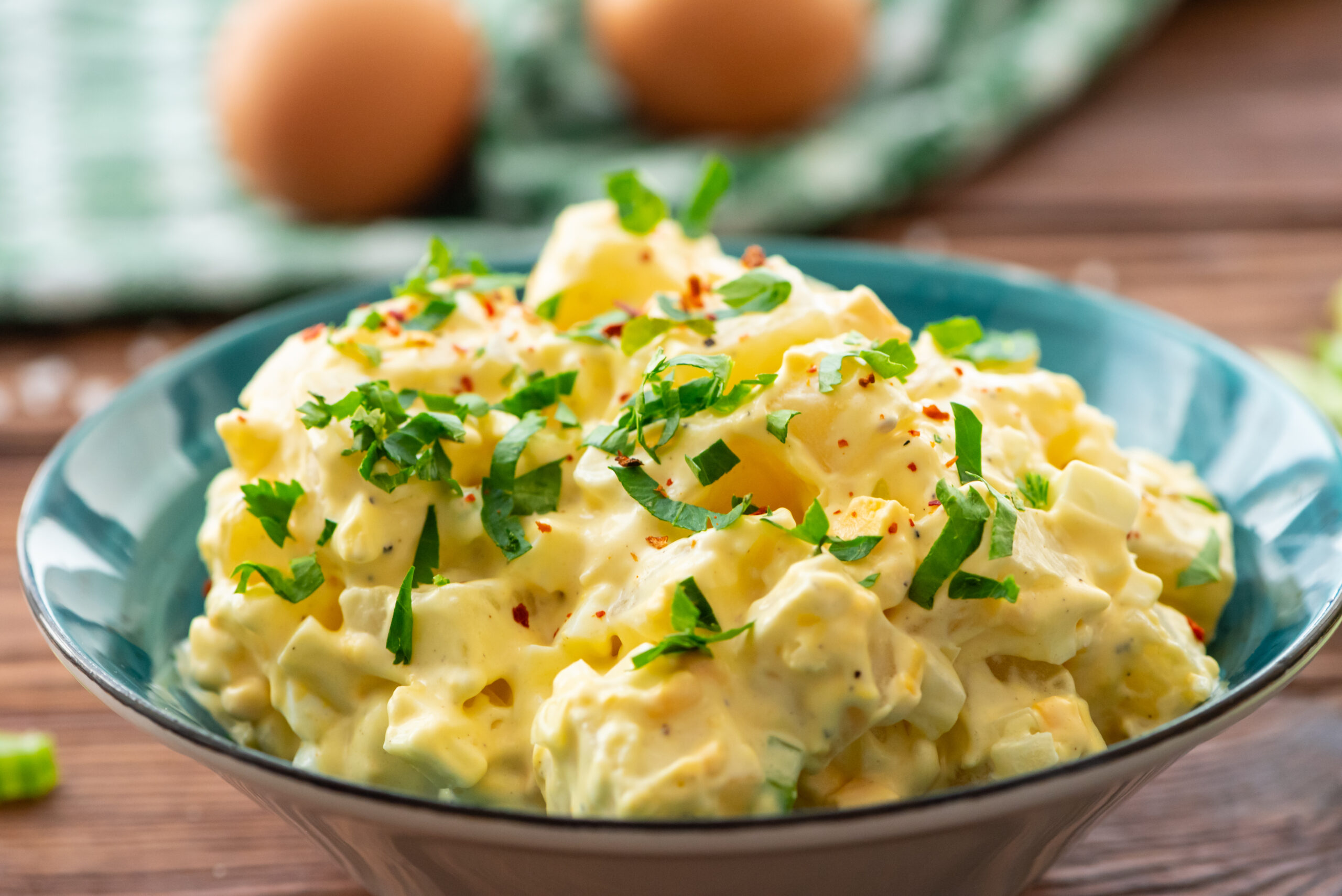 a bowl of potato salad with chopped cilantro on top.