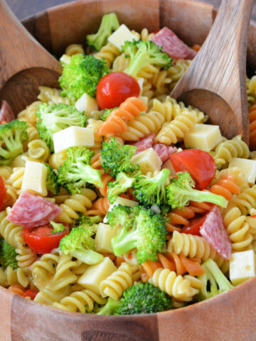 tender rotini noodles coated in Italian dressing with added broccoli, salama, mozzarella, and tomatoes