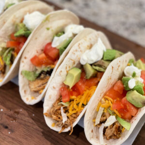 shredded chicken served in tortillas with your favorite toppings