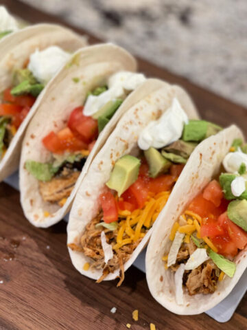 shredded chicken served in tortillas with your favorite toppings