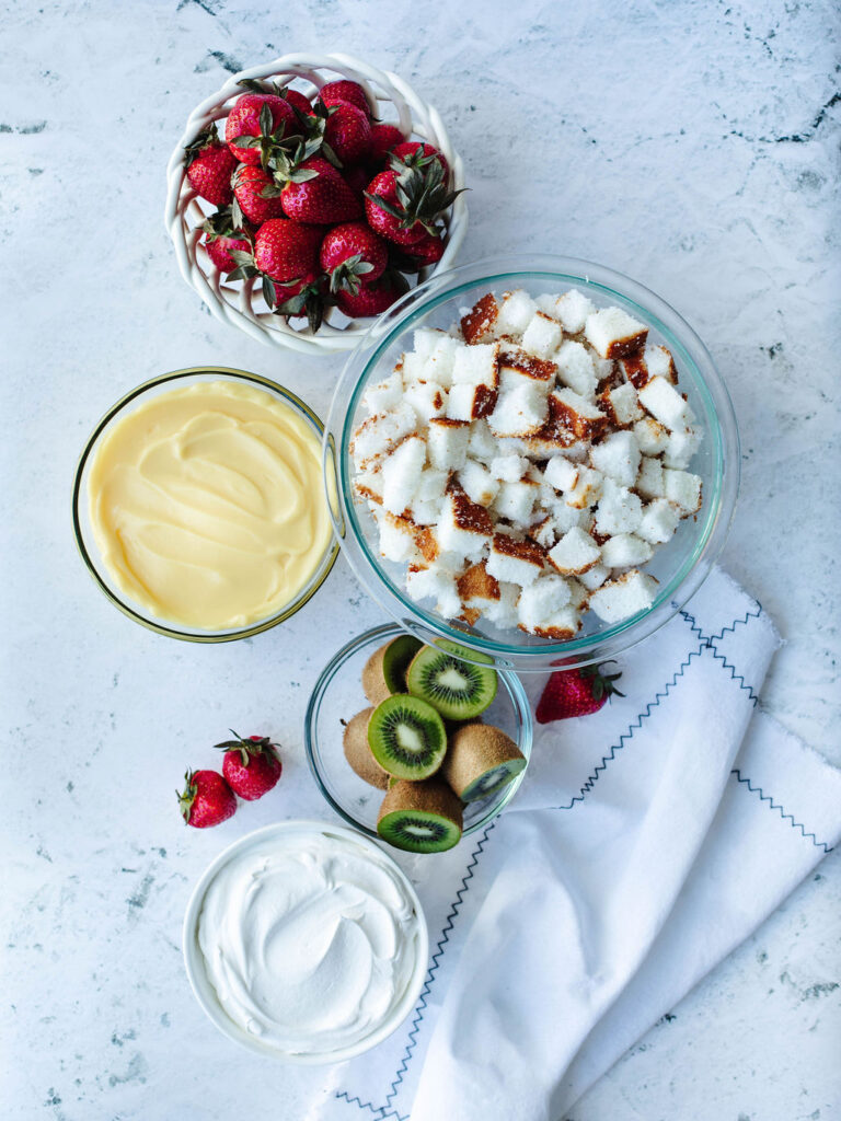 all the ingredients needed to make an angel food cake fruit trifle.