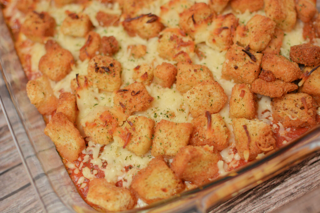 croutons on top of a chicken casserole for a shortcut chicken parmesan bake.