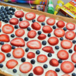 sugar cookie crust with a cream cheese frosting and fresh cut fruit on top