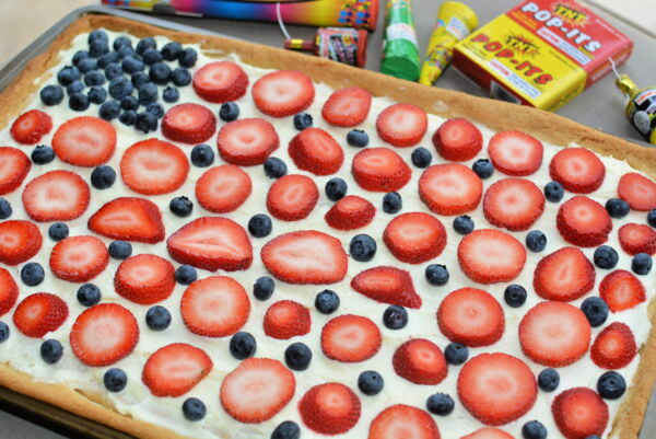 sugar cookie crust with a cream cheese frosting and fresh cut fruit on top