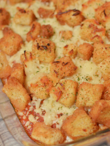 croutons on top of a chicken casserole for a shortcut chicken parmesan bake.