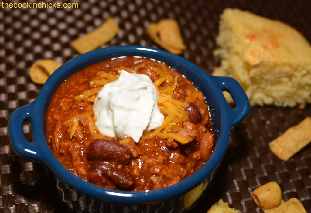 flavorful chili topped with sour cream and cheese and served with cornbread