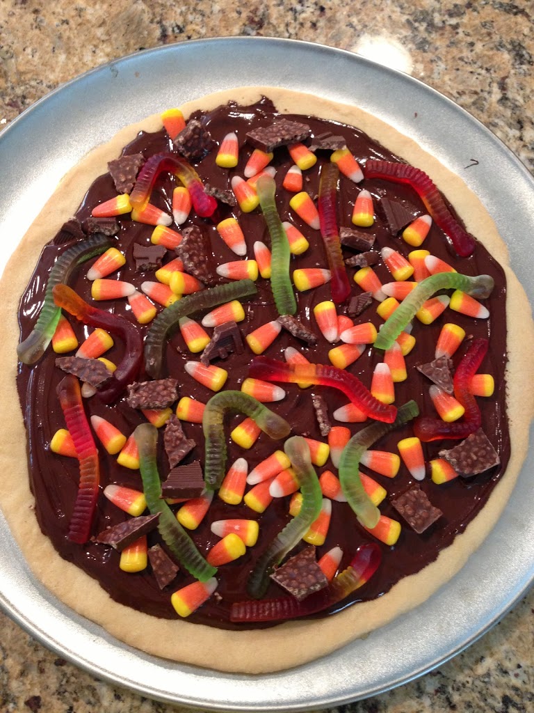 Halloween pizza made with sugar cookie dough and Halloween candy