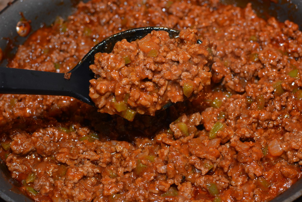 ground beef, ketchup, peppers, onions, and mustard combined into a classic sloppy joe recipe