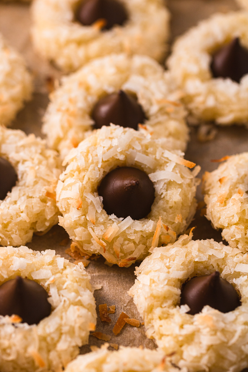 macaroon kiss cookies on a wood platter.