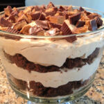 layers of peanut butter, brownies, and peanut butter cups combined into a trifle