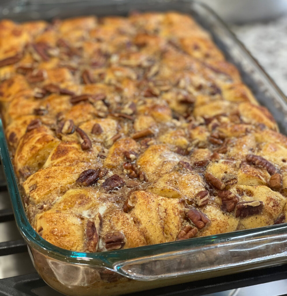 cinnamon roll pieces combined with syrup and pecans