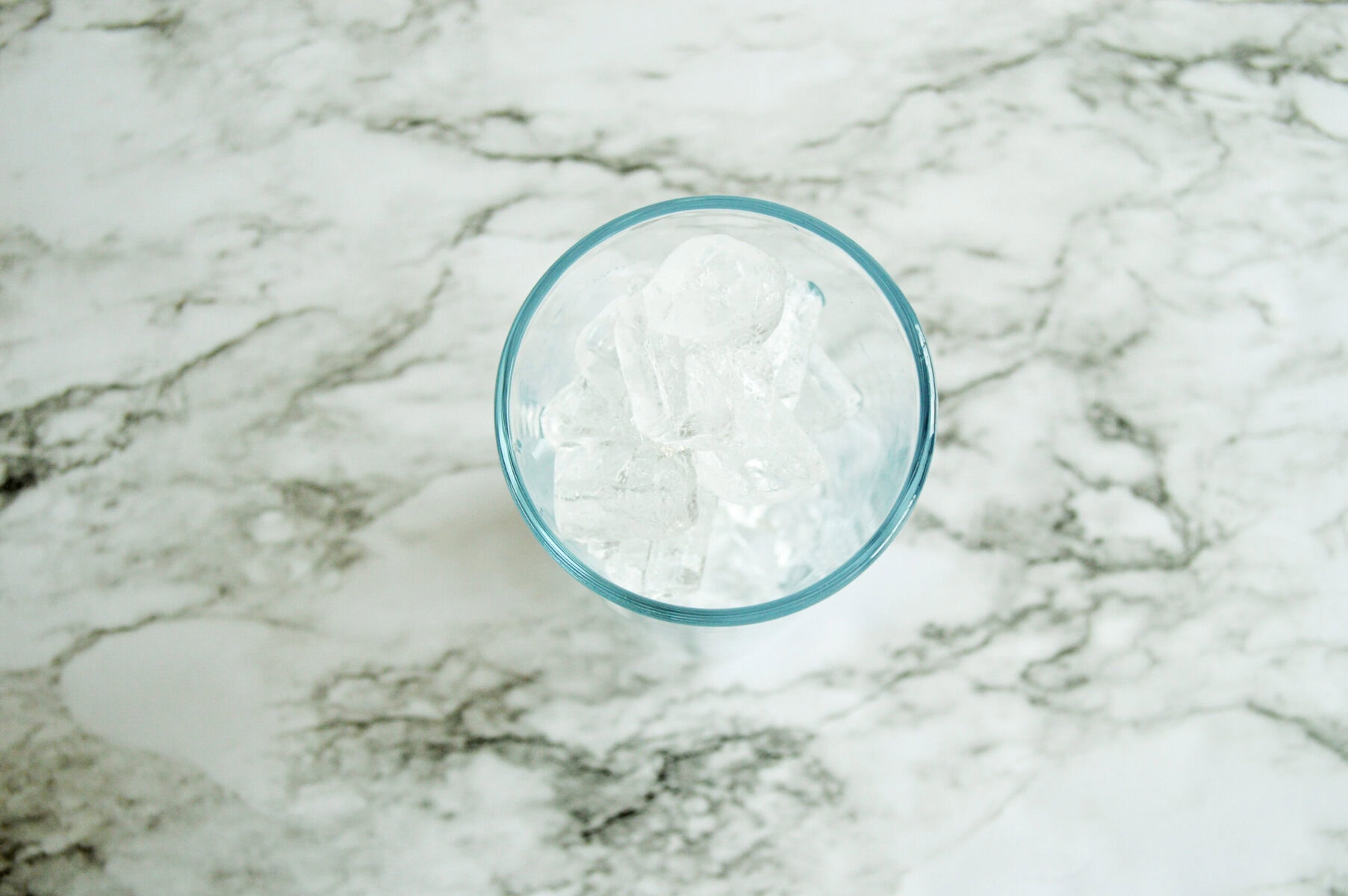 a glass filled with ice cubes.