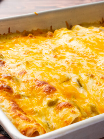 sour cream covered chicken enchiladas with melted cheese
