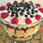 layers of lemon pound cake with pudding and fruit combined into a trifle
