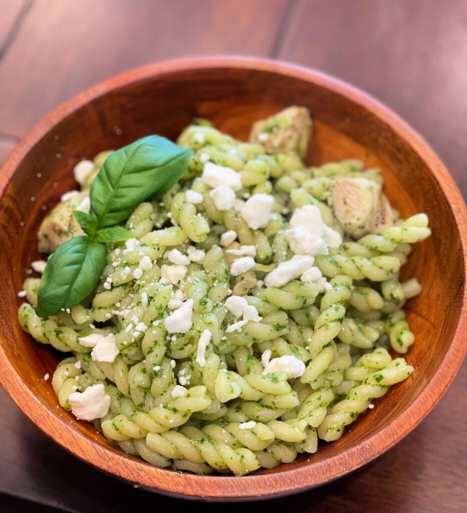 fresh pesto pasta with feta cheese on top