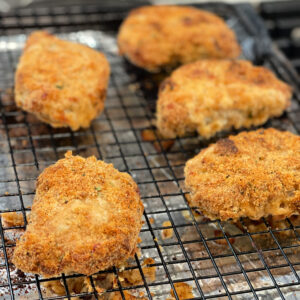 ranch dipped pork chops covered in a bread crumb mixture and baked