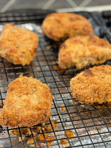 ranch dipped pork chops covered in a bread crumb mixture and baked