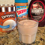 ice-cream, peanut butter, and chocolate syrup combined to create a flavorful peanut butter cup milkshake