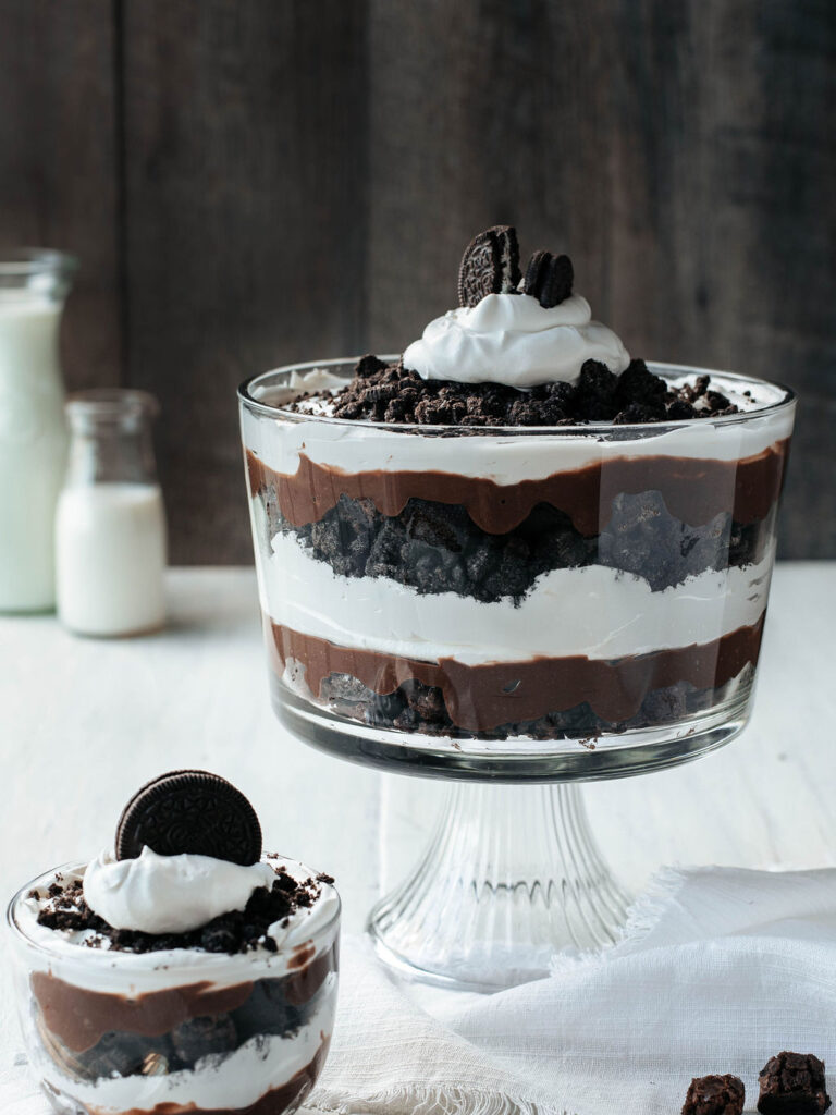 layers of brownies, cool whip, pudding, and Oreos, in a trifle bowl.