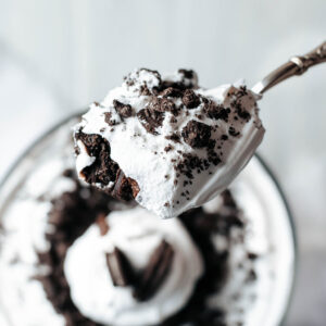 a serving spoon taking a scoop out of a trifle bowl.