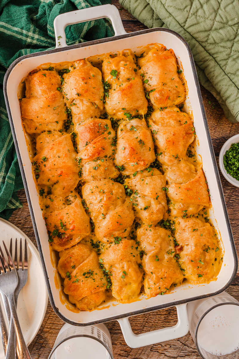 a baked crescent roll casserole with tender chicken and a creamy cheese sauce on top.