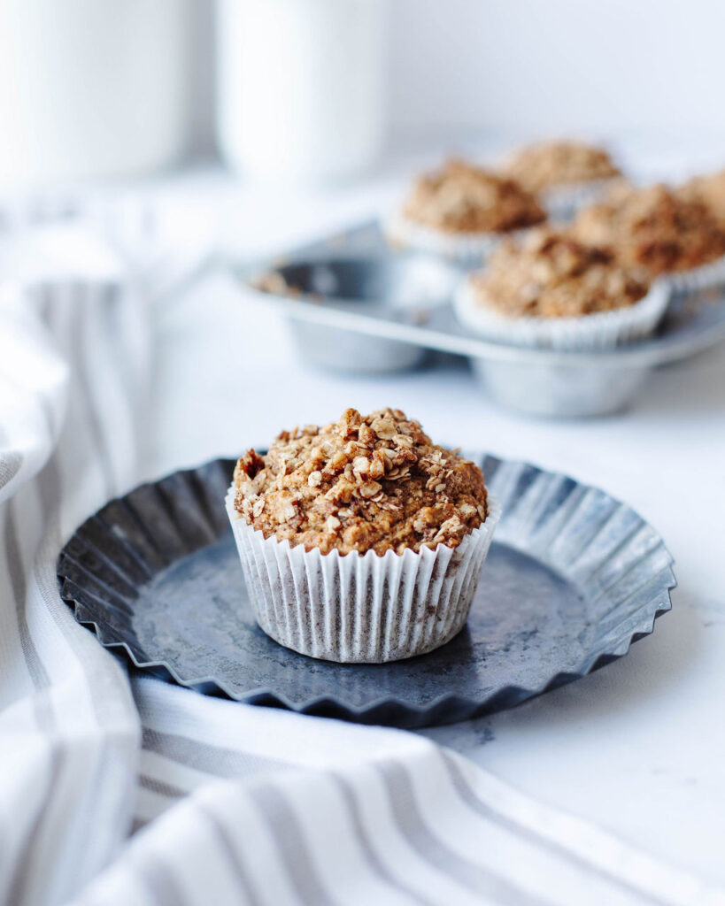 a healthy baked muffin on a black plate.