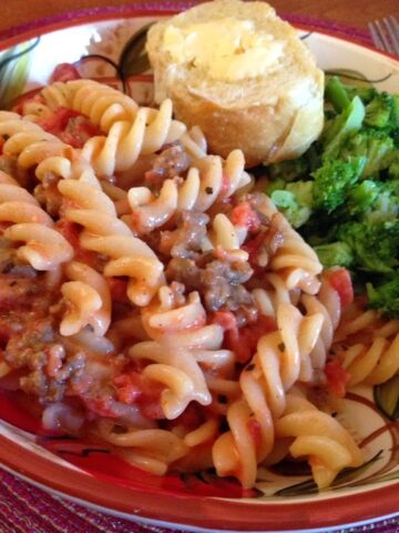 tender pasta with a creamy tomato sauce on top and crumbled sausage throughout