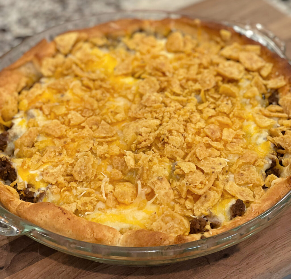 taco seasoned beef combined with corn chip over crescents to form a taco pie