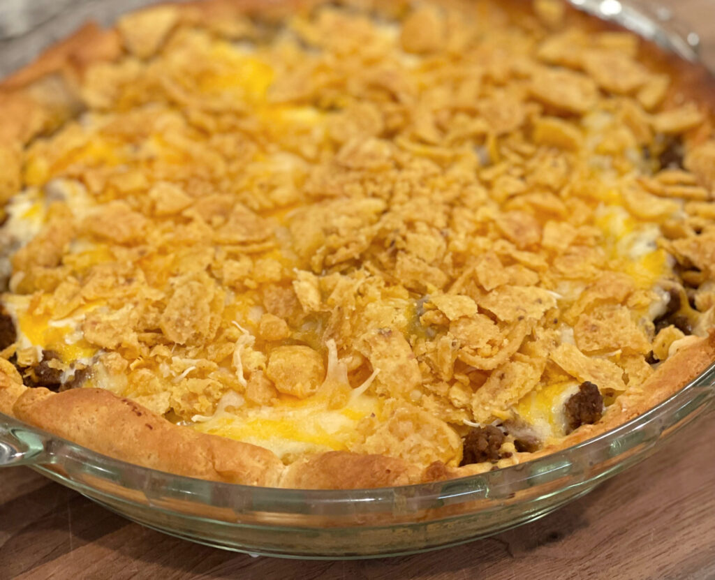 layers of taco seasoned beef, corn chips, cheese, and crescents to form a pie