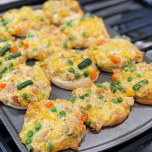 chicken, vegetables, cheese, and biscuits combined into muffin cups