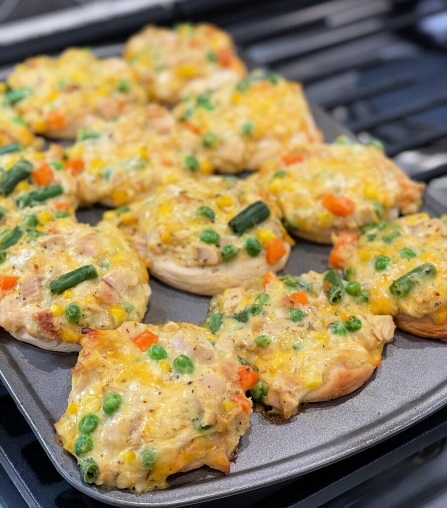 chicken, vegetables, cheese, and biscuits combined into muffin cups