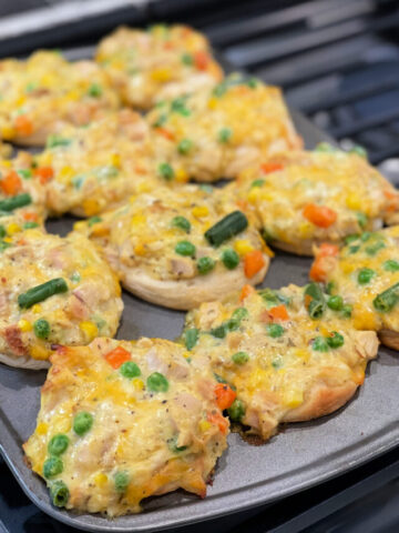 chicken, vegetables, cheese, and biscuits combined into muffin cups