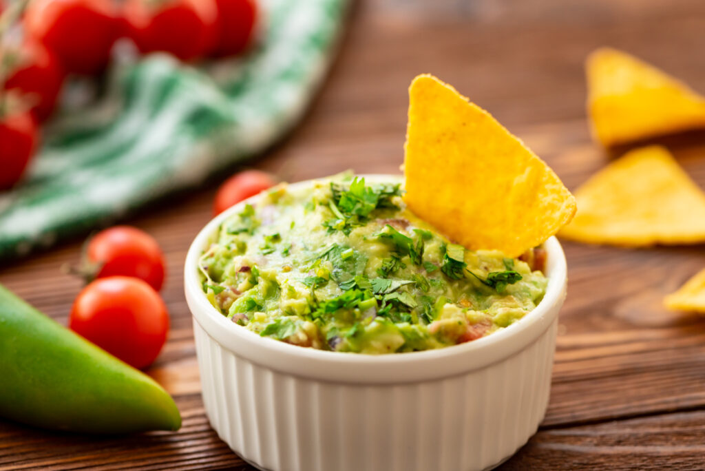 authentic guacamole made by combining mashed avocado, lime, cilantro, garlic, and jalapeno