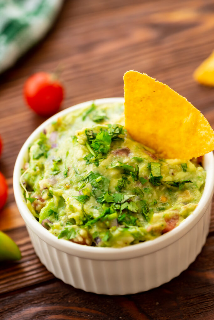 a flavor packed mexican dip consisting of avocados, garlic, onion, lime, and cilantro