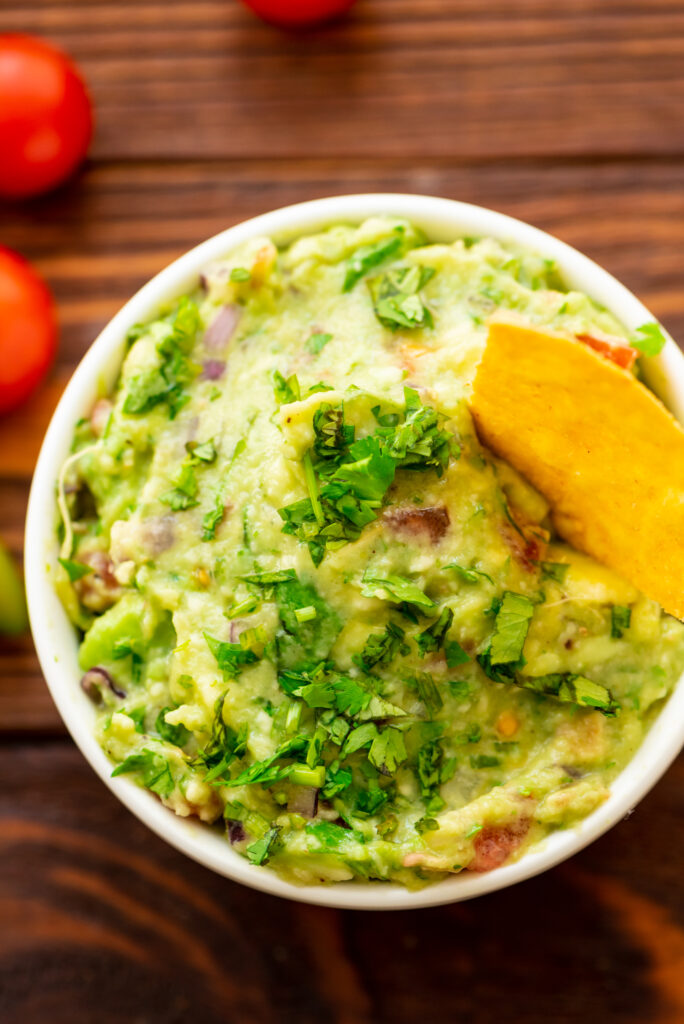 avocados mashed and combined with onion, cilantro, garlic, and lime juice to create a flavorful guacamole