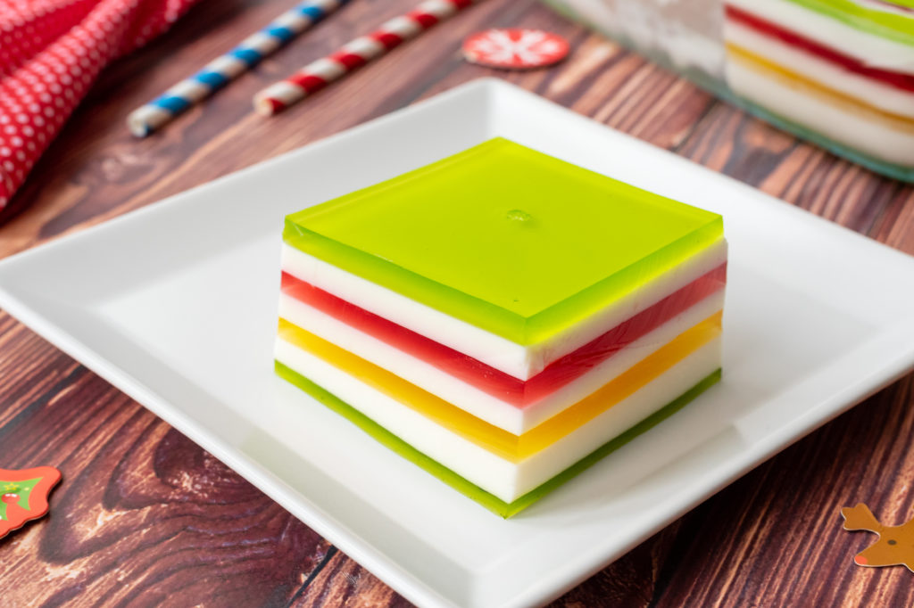a slice of jello with colorful layers for christmas