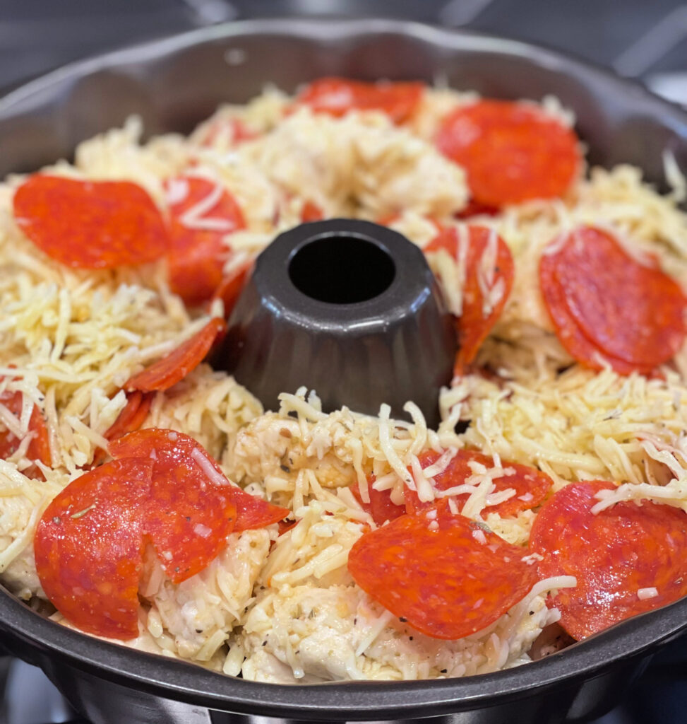 tender biscuit pieces with cheese and pepperoni to create a pizza