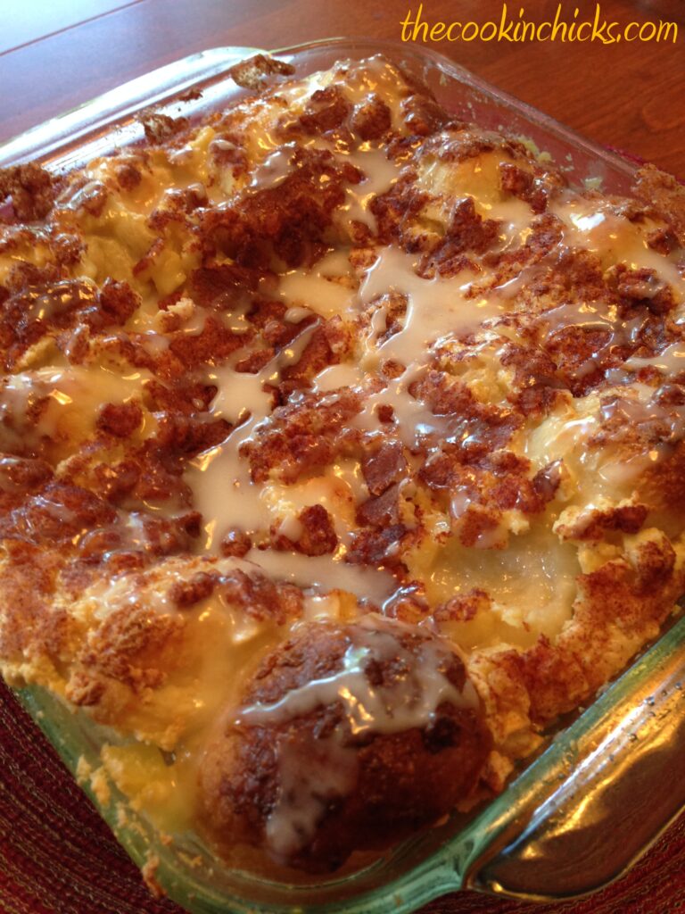 cut up rolls combined with apple pieces, cream cheese, spices, and a glaze in this apple cinnamon cream cheese bake