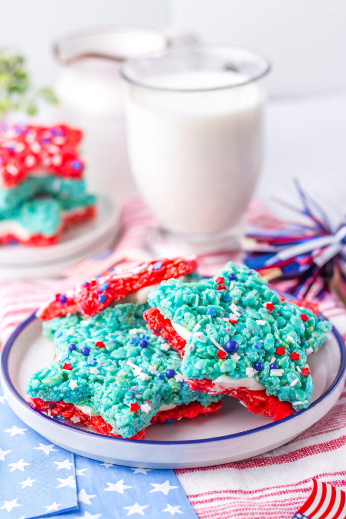star shaped rice cereal dessert served on a plate with a glass of milk.