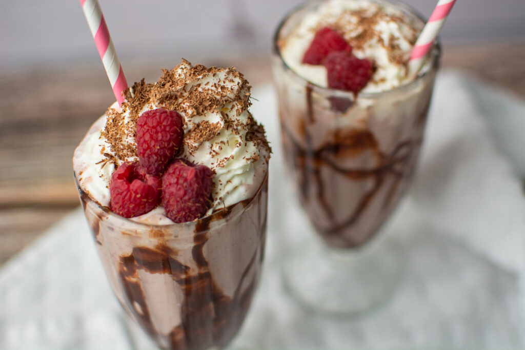 colored straws inside a creamy and delicious ice cream shake.