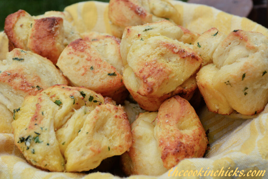 pull apart biscuit pieces coated in butter and garlic to form mini garlic monkey bread