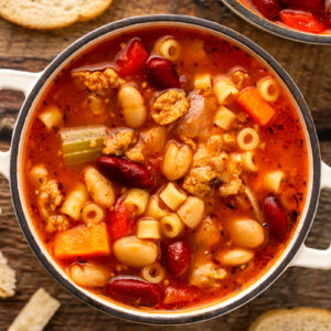 a soup bowl with hearty Italian soup inside and crusty bread.