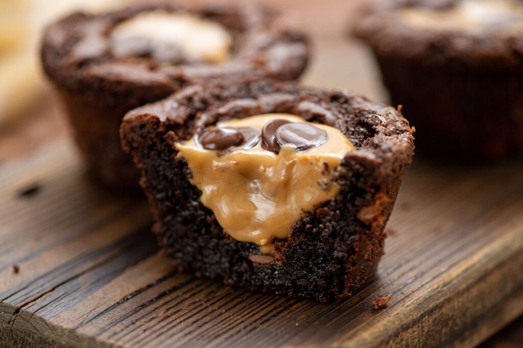 melted peanut butter inside a chocolate brownie cup