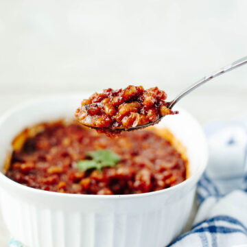 bbq baked beans in a white casserole dish.
