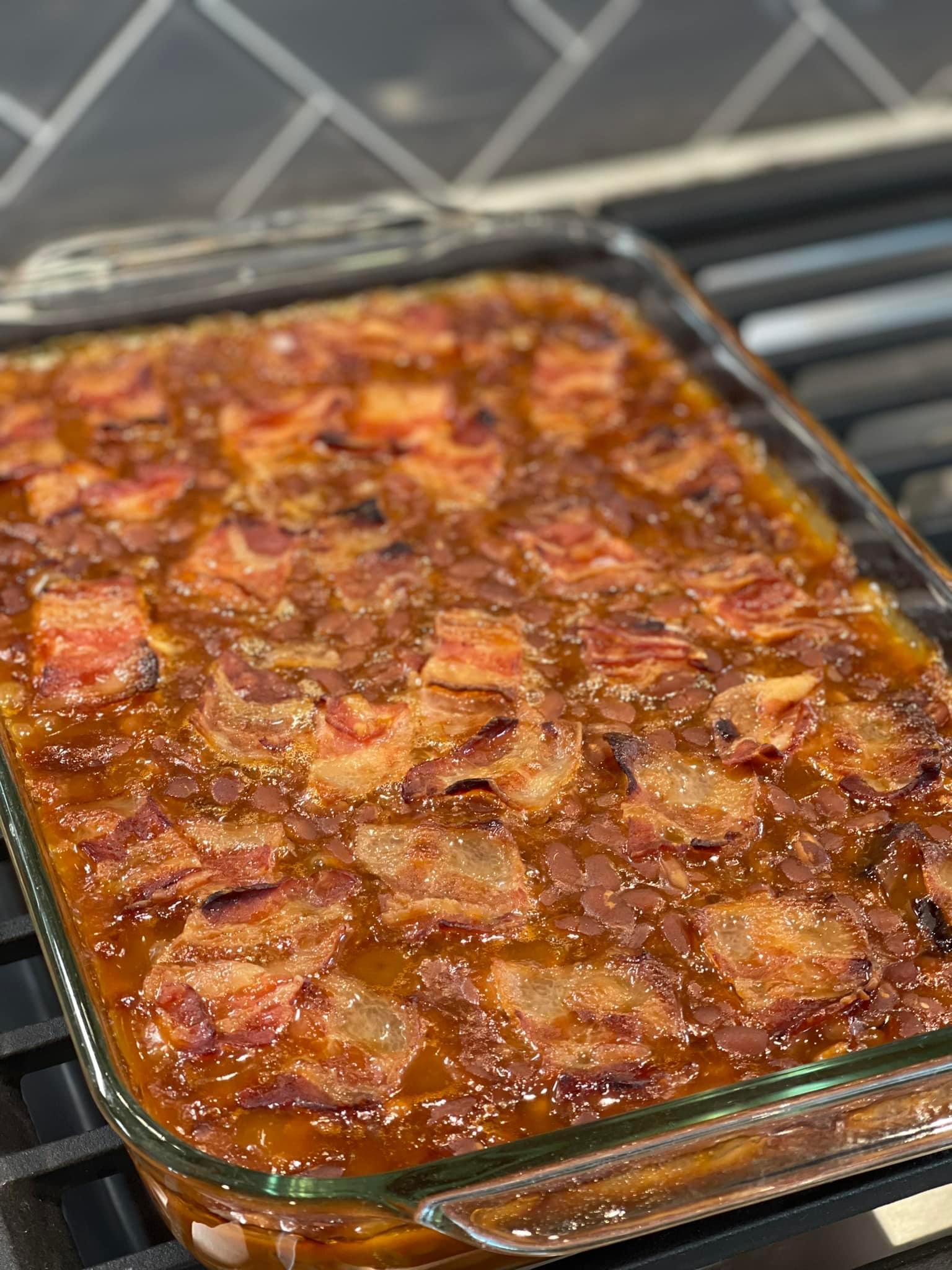BBQ baked beans topped with bacon and baked in a glass 9x13 baking pan.