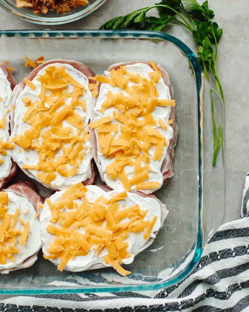 shredded Cheddar cheese sprinkled on top of pork.
